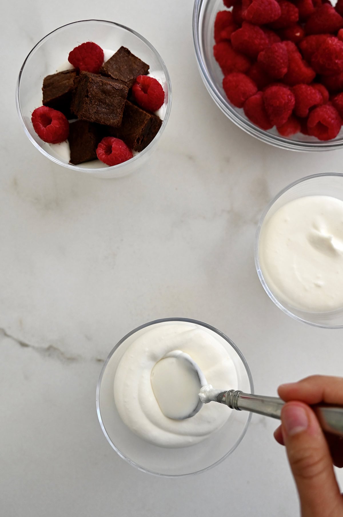 Assembling the mini trifles into dessert cups.