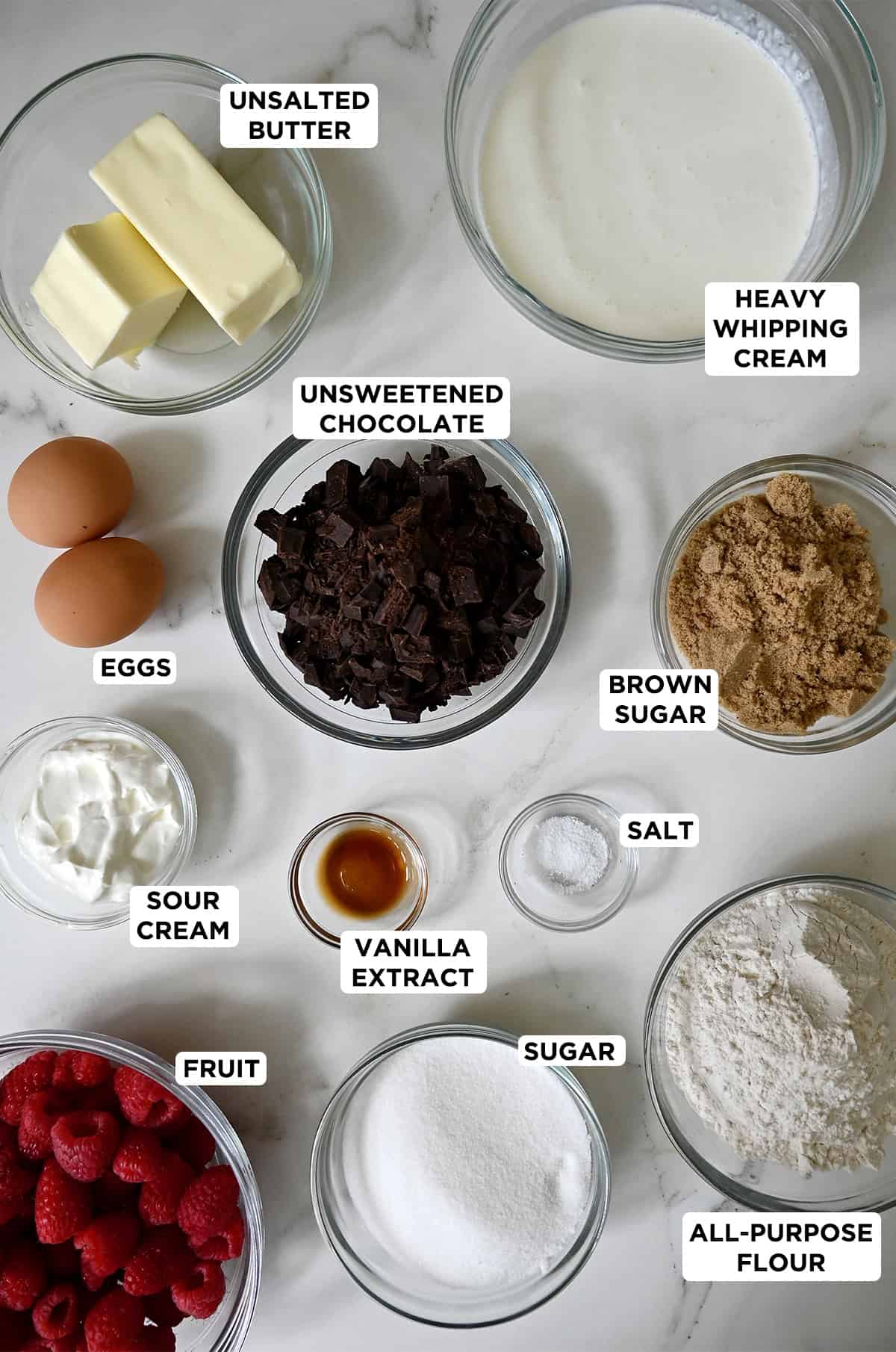 Brownie trifle ingredients in various sizes of glass bowls.