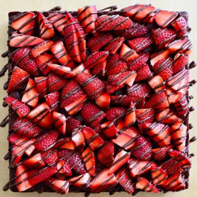 A top-down view of Chocolate-Covered Strawberry Brownies drizzled with chocolate